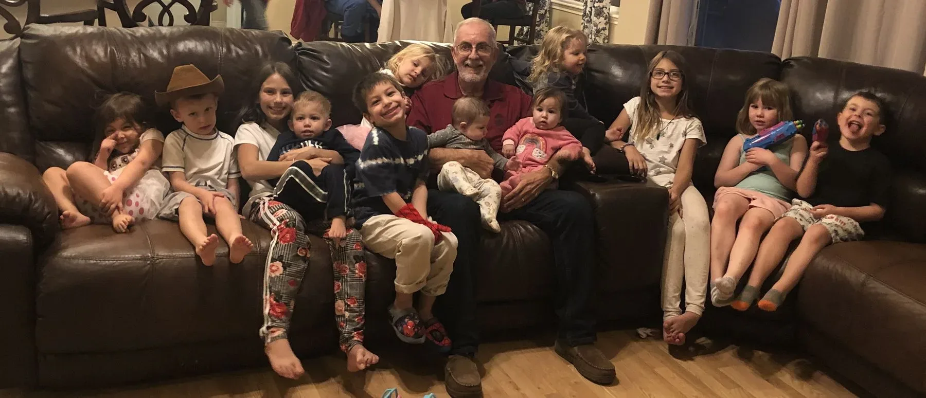 A Flock client on the couch with his grandchildren